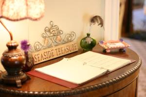a desk with a clock and a paper on it at Captain Farris House in South Yarmouth