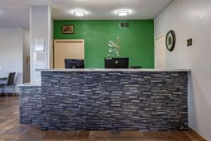 a lobby with a bar with a green wall at Quality Inn Kirksville in Kirksville