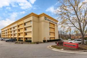 a hotel building with a parking lot in front of it at Quality Inn & Suites Raleigh Durham Airport in Morrisville