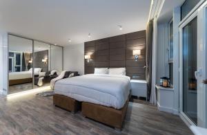 a bedroom with a large bed and a large mirror at VICTORY-21 LUXURY APARTMENT CEnTER in Kyiv