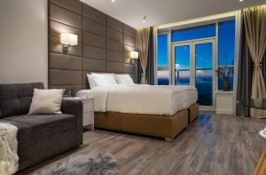 a hotel room with a bed and a couch at VICTORY-21 LUXURY APARTMENT CEnTER in Kyiv