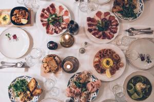 a white table with plates of food on it at Chez Marie in Linguizzetta +64 photos