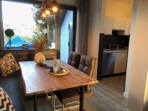 a kitchen and dining room with a wooden table at Fennies Hütte in Medebach