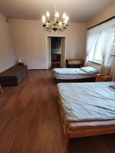 a room with a bed, a desk and a window at Apartament Rodzinny in Nowy Targ