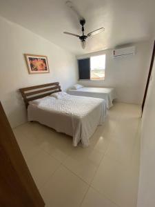 1 dormitorio con 2 camas y ventana en Casa 4/4(Amplos), Cond. fechado com piscina-150m2, en Salvador