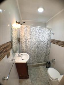 y baño con lavabo y aseo. en Hostal Puritama en San Pedro de Atacama