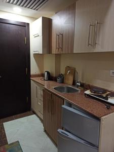 a kitchen with a sink and a counter top at 2nd Cecilia beach resort studio in Hurghada