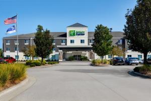 a hotel with cars parked in a parking lot at Holiday Inn Express Atmore, an IHG Hotel in Atmore