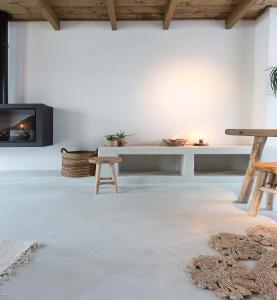 a living room with a fireplace and a table at Boutique Holiday Home Zalig In Antwerpen in Antwerp