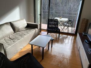 a living room with a couch and a table at Dúplex Roca del Sucut in Ribes de Freser