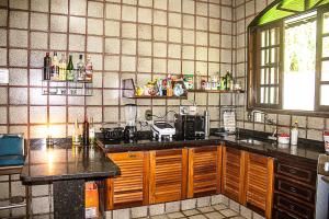 a kitchen with a sink and a counter top at BASE CAMP, Guest House, Surf House , Itamambuca, Ubatuba in Ubatuba