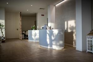 a lobby with a desk with a person on it at Stellamare in Caorle