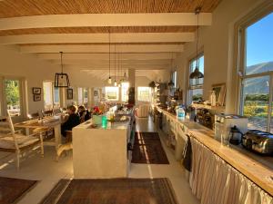 a large kitchen with people sitting at a counter at The Olive House, Prince Albert in Prince Albert