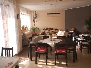 a dining room with tables and chairs and a living room at Willa Konda in Białka Tatrzańska