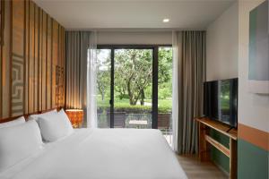 Postel nebo postele na pokoji v ubytování The Peri Hotel Khao Yai