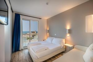 a bedroom with a bed and a large window at Stellamare in Caorle