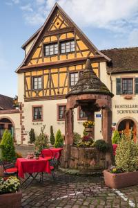 a building with a gazebo in front of it at Hostellerie Schwendi in Kientzheim