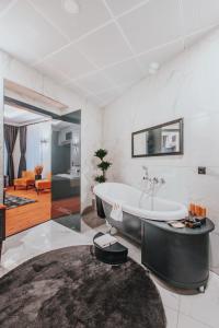 a bathroom with a tub and a large rug at Ferman Port Hotel - Special Category in Istanbul