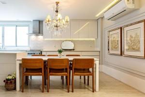 a kitchen with a table with chairs and a chandelier at WI-FI 240MB | Centro de Florianópolis #CA19 in Florianópolis