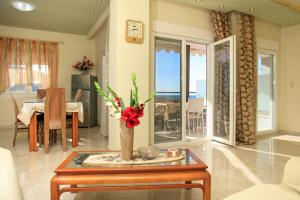 a living room with a vase of flowers on a table at Loridis View Apartments in Prinos