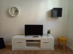 a white cabinet with a tv on top of it at Falkennest-lu in Ludwigshafen am Rhein