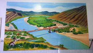 a mural of a bridge over a river and a road at Hostal Las Palmeras in Jaén