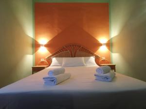 Postel nebo postele na pokoji v ubytování Hotel Villa Orio & Beatrice