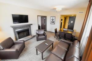 a living room with a couch and a fireplace at Canad Inns Health Sciences Centre in Winnipeg