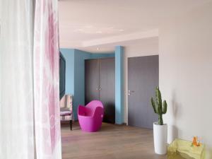 a pink chair in a room with a cactus at Le Clos Du Lac - location de chambres in Veyrier-du-Lac