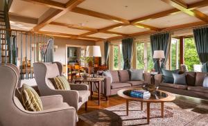 a living room with couches and a table at Sheen Falls Lodge in Kenmare