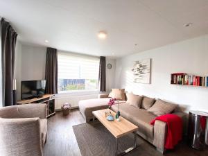 a living room with a couch and a table at Vakantiechalet Serooskerke SE04 in Serooskerke