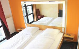Postel nebo postele na pokoji v ubytování Hotel Victoria