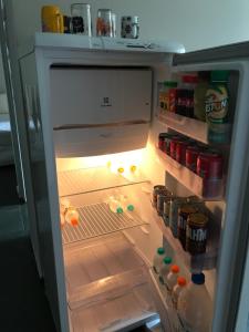 an open refrigerator with its door open and food inside at Casa Aconchego in Itu