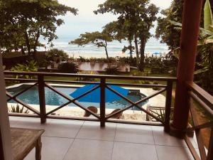 a view from the balcony of a resort with a swimming pool at Paradiso Al Mare in Camburi