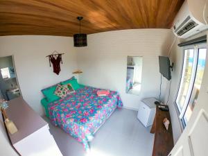 a bedroom with a bed in a small room at Casa dos Tubarões in Fernando de Noronha