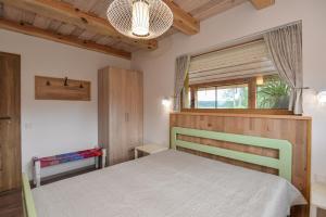 a bedroom with a bed and a window at Vila LATO, Druskininkai in Latežeris