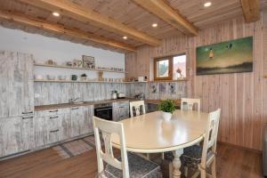 a kitchen with a table and chairs in a room at Vila LATO, Druskininkai in Latežeris +22 photos