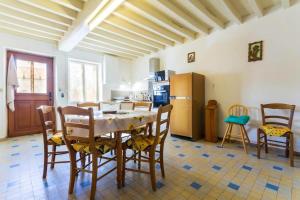 a kitchen with a table and chairs and a refrigerator at Maison de 3 chambres avec jardin clos et wifi a Moraches in Moraches