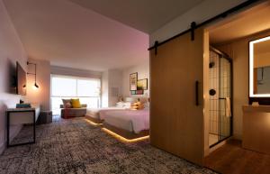 a bedroom with a bed and a dresser at Reverb by Hard Rock Atlanta Downtown in Atlanta