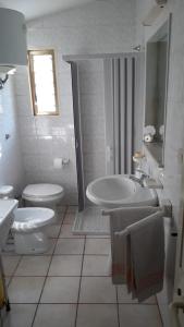 a white bathroom with a sink and a toilet at Villa nel Salento - Casa Maria e Casa Glory in Porto Cesareo +21 photos
