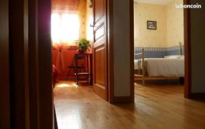 a room with a bedroom with a bed and a table at Chambres d'Hôtes : chez Mamie Riclaude in Orsan