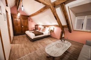 a bedroom with a bed and a table in a room at La Brocherie in Magny-le-Désert