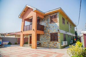 a house with a building with at Bays Boutique Apartment in Accra