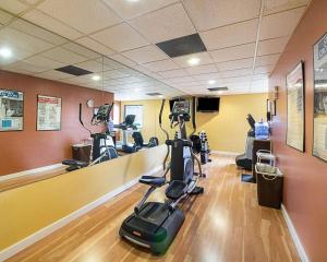 a gym with treadmills and ellipticals in a room at Shary Inn and Suites in Mission