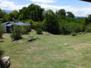 a small house in a field with a yard at 7 esencias in Villa Yacanto