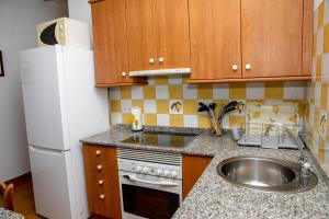 A kitchen or kitchenette at El Molinet del Governador- Apartamentos Rurales