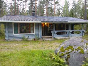 a small house in the middle of a field at Holiday Cabin Kerimaa 121 in Savonlinna