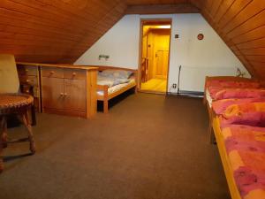 a attic bedroom with a bed and a doorway at Chalupa Paseky in Paseky nad Jizerou