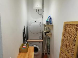a laundry room with a washing machine and a lamp at Old Town House La Laguna in Las Lagunas