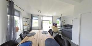 a living room with a wooden table and chairs at Villa Lathum in Lathum